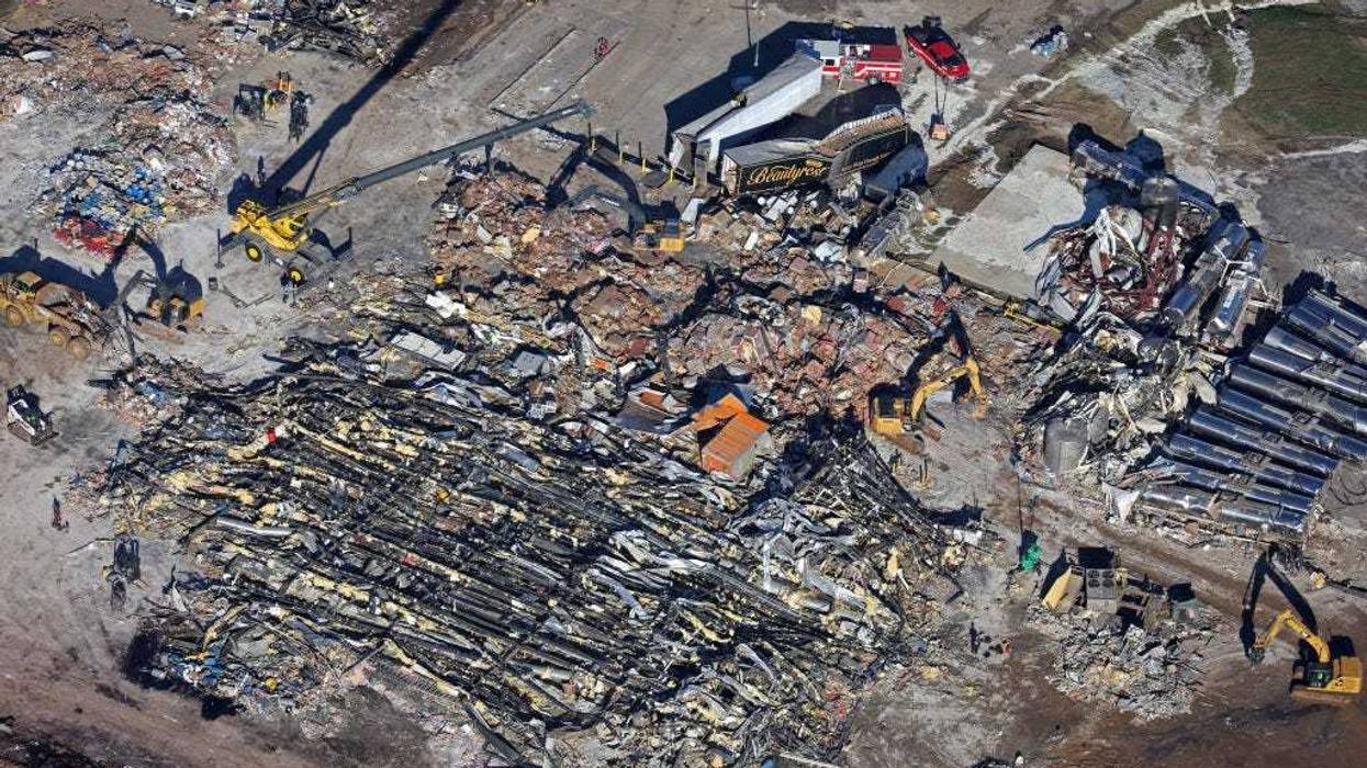 In this aerial view, crews clear the rubble at the Mayfield Consumer Products candle factory after it was destroyed by a tornado three days prior, on December 13, 2021 in Mayfield, Kentucky. Multiple tornadoes struck several Midwest states in the late evening on December 10, causing widespread destruction and multiple fatalities. (Photo by Scott Olson/Getty Images)