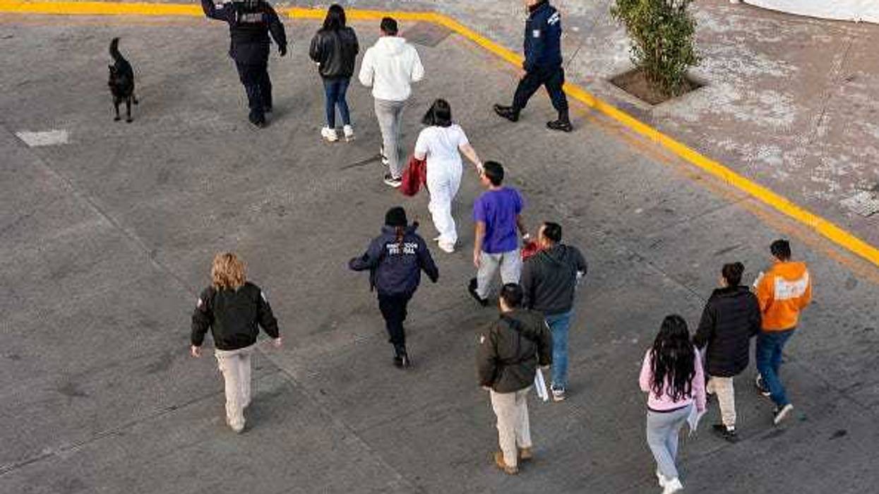 In this aerial view, Mexican immigration officials and police escort deportees after they were sent back into Mexico on January 22, 2025 as seen from Nogales, Arizona. U.S. President Donald Trump signed executive orders on his first day in office declaring a state of emergency at the U.S. southern border, halting asylum claims and launching a campaign of mass deportations. (Photo by John Moore/Getty Images)
