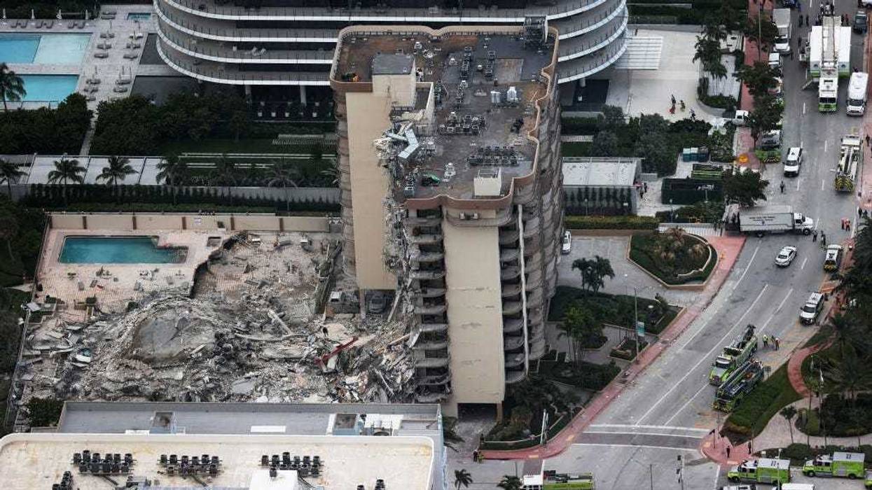 In this aerial view, search and rescue personnel work after the partial collapse of the 12-story Champlain Towers South condo building on June 24, 2021 in Surfside, Florida.