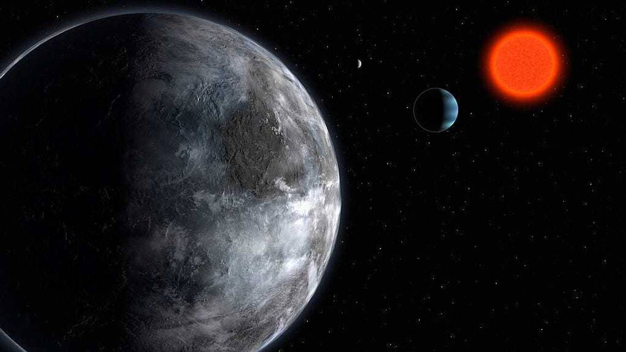 In this artist's impression supplied by the ESO (European Southern Observatory) on April 25, 2007, the planetary system around the red dwarf, Gliese 581, is pictured showing what astronomers believe is the most earth like planet found outside our solar system to date.
