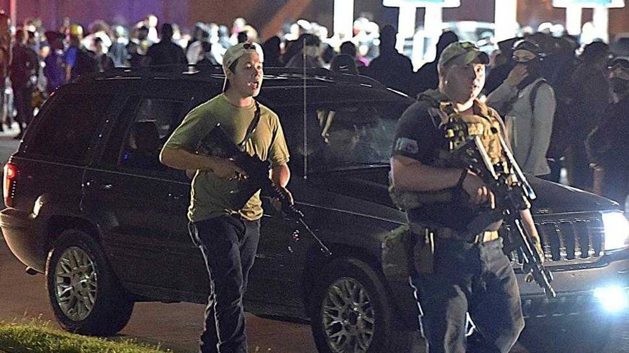 In this Aug. 25, 2020, file photo, Kyle Rittenhouse, left, with backwards cap, walks along Sheridan Road in Kenosha, Wis., with another armed civilian. Rittenhouse was among a number of armed white men who converged on the city this summer, claiming to protect property owners from arson and theft, one example of political or social unrest that has caused increased anxiety levels among African Americans.