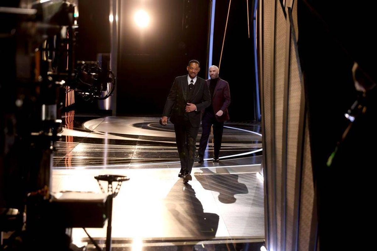 In this handout photo provided by A.M.P.A.S., Will Smith walks off stage during the 94th Annual Academy Awards at Dolby Theatre on March 27, 2022 in Hollywood, California.