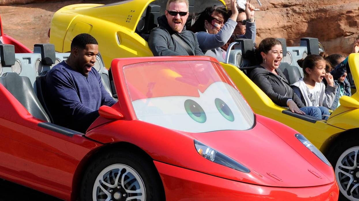 In this handout photo provided by Disney Parks, host Michael Strahan gears up for "LIVE's" five shows from Disneyland Resort with a ride on the Cars Land Radiator Springs Racers at Disney California Adventure on May 16, 2015 in Anaheim, California.