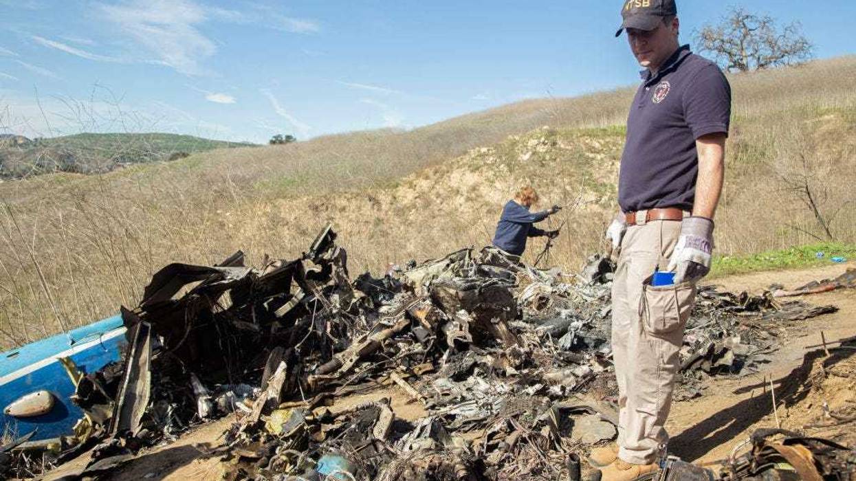 In this handout photo provided by the National Transportation Safety Board, investigators work at the scene of the helicopter crash that killed former NBA star Kobe Bryant and his 13-year-old daughter Gianna on January 27, 2020 in Calabasas, California. All nine people on board, including the pilot, died in the crash.