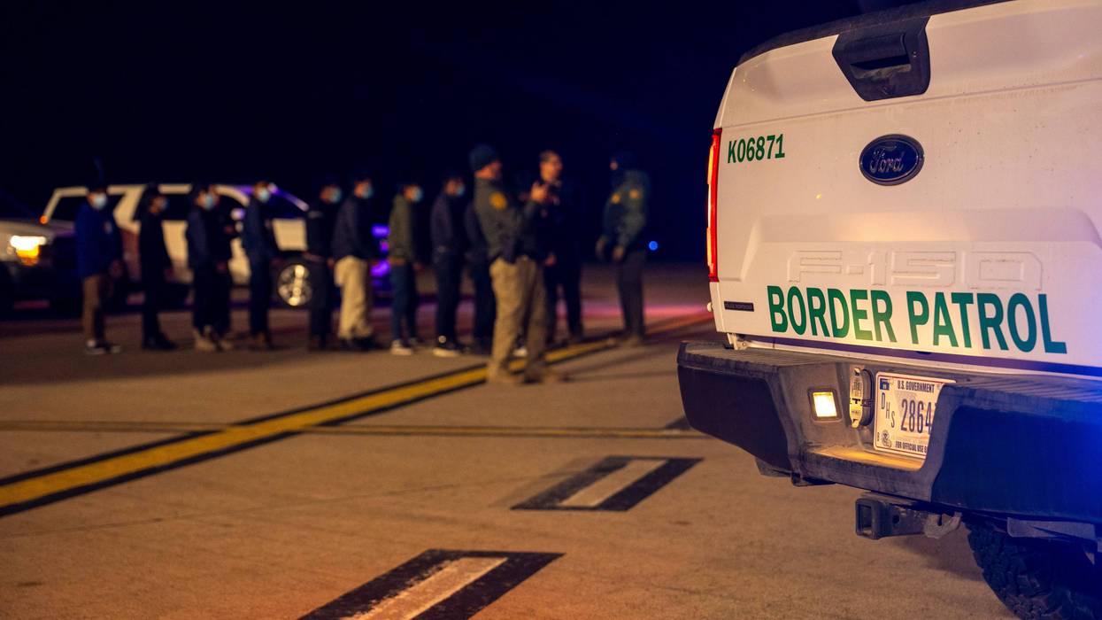In this handout provided by the U.S. Department of Defense, U.S. Customs and Border Protection Agents guide illegal immigrants to board C-17 Globemaster III aircraft at the Tucson International Airport, on January 23, 2025 in Tucson, Arizona.