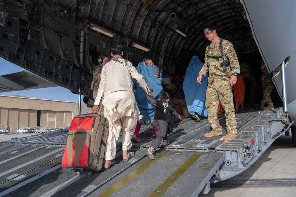In this handout provided by U.S. Central Command Public Affairs, U.S. Air Force loadmasters and pilots assigned to the 816th Expeditionary Airlift Squadron, load passengers aboard a U.S. Air Force C-17 Globemaster III in support of the Afghanistan evacuation at Hamid Karzai International Airport (HKIA) on August 24, 2021 in Kabul, Afghanistan.
