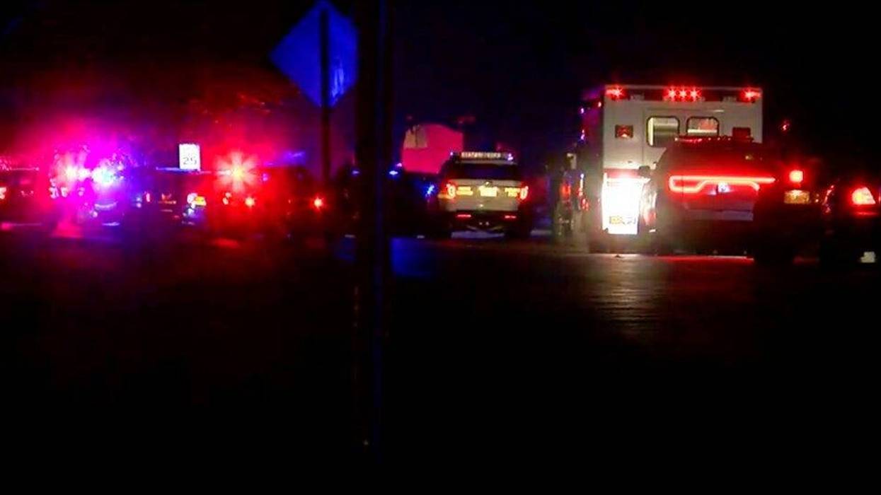 In this image made from a video provided by FOX19Now.com lights illuminate police vehicles as authorities respond to a standoff at an apartment complex in Ohio, about 20 miles east of Cincinnati on Sunday, Feb. 3, 2019.