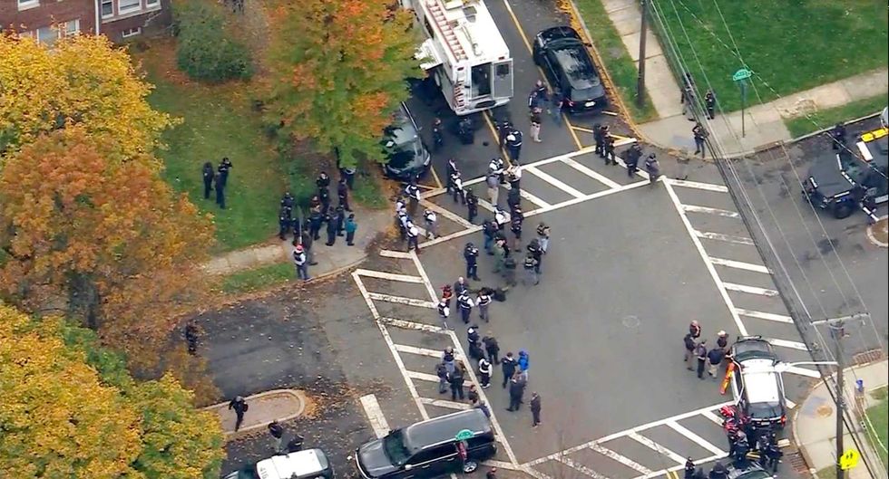 In this image provided by WABC-TV, police respond to a report of officers shot Tuesday, Nov. 1, 2022, in Newark, N.J
