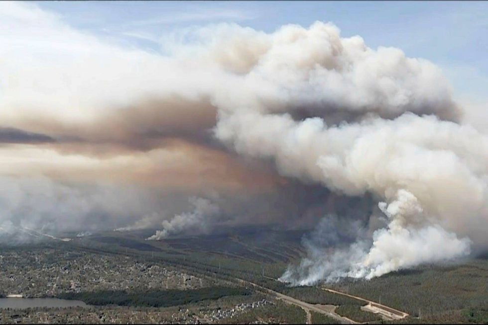In this image taken from aerial video shows smoke rising from wildfires in Ocean County, N.J., Wednesday, April 23, 2025.