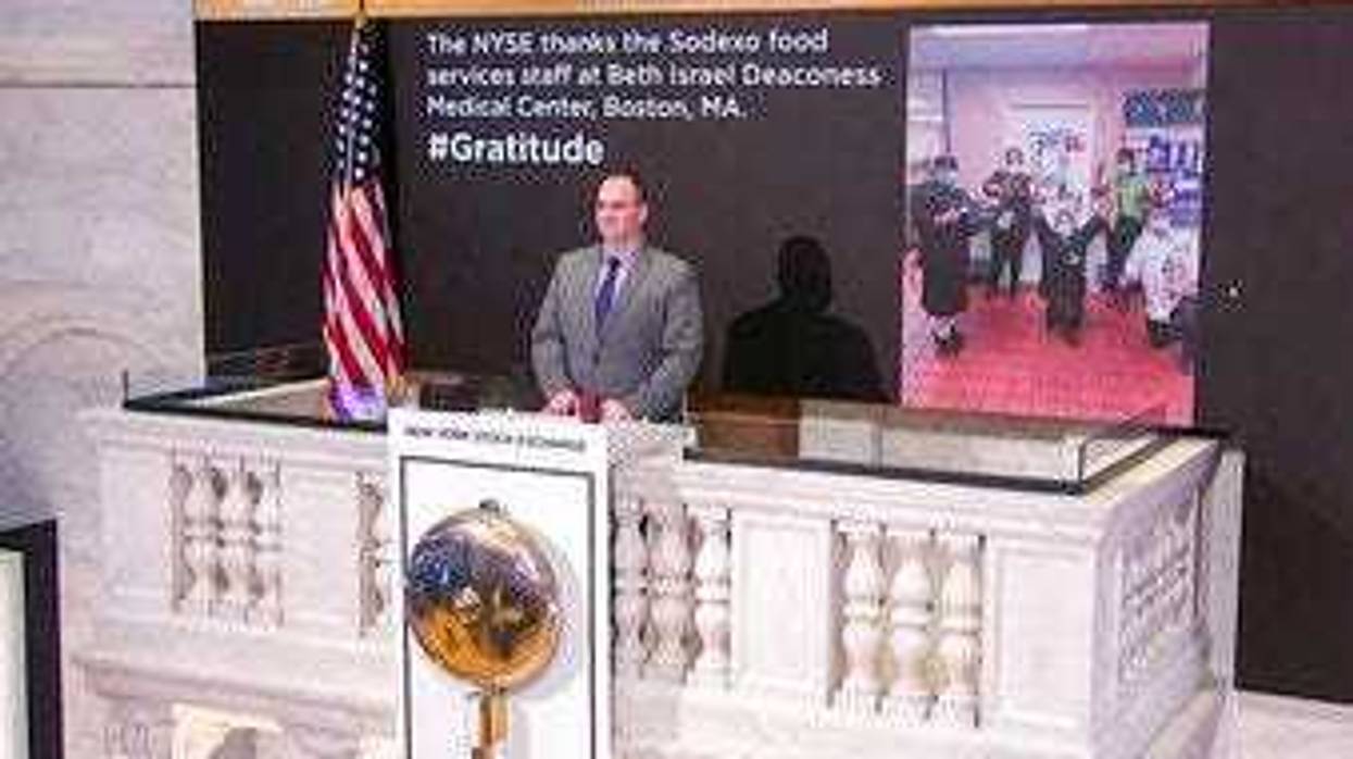 In this image taken from video provided by the New York Stock Exchange, Tommy Gannon, Assistant Supervisor, Facilities, rings the opening bell at the NYSE. (New York Stock Exchange via AP)