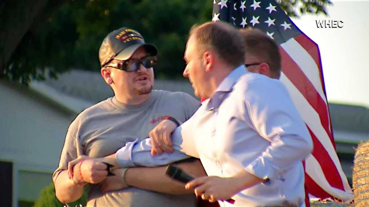 In this image taken from video provided by WHEC-TV, David Jakubonis, left, brandishes a sharp object as he attacks U.S. Rep. Lee Zeldin, right, as the Republican candidate for New York governor delivered a speech in Perinton, N.Y., Thursday, July 21, 2022
