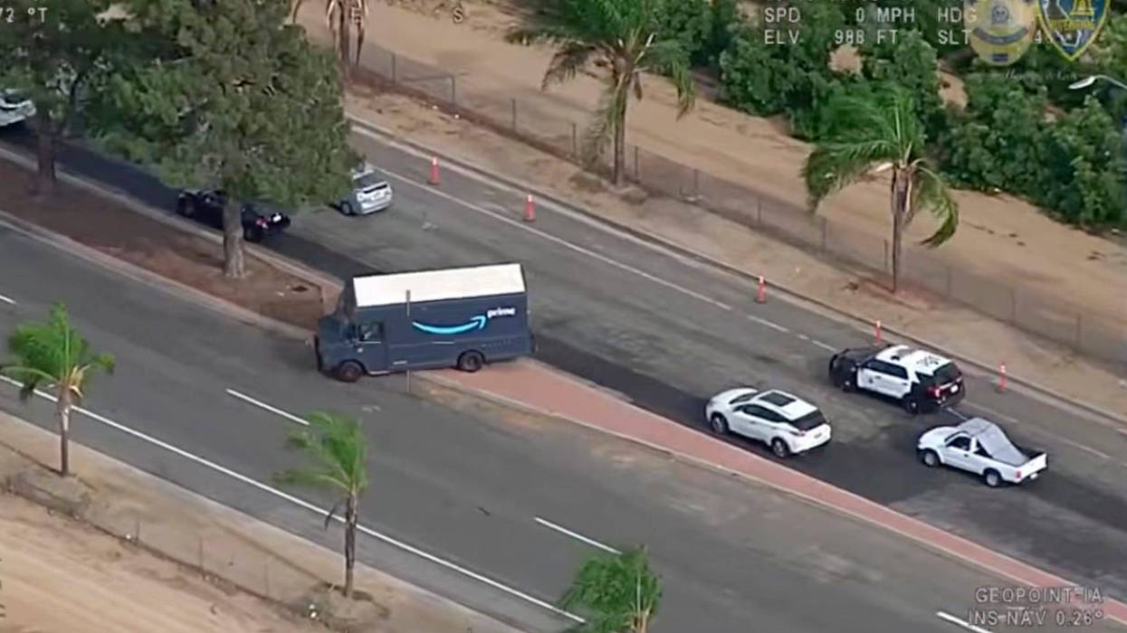 In this image taken from video released by the Riverside Police Department, police pursue of a man driving a stolen Amazon truck in Riverside, Calif., Monday, July 25, 2022. A Nevada man was arrested after police say he committed two brazen home invasion robberies, then stole an Amazon delivery truck and crashed into multiple cars as he led authorities on a chase throughout a Southern California city. Riverside police were able to use GPS tracking to locate the stolen truck.
