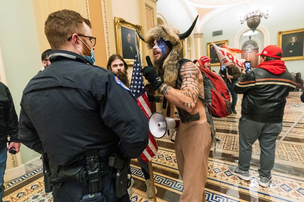 In this Jan. 6, 2021, file photo supporters of President Donald Trump are confronted by U.S. Capitol Police officers outside the Senate Chamber inside the Capitol in Washington.