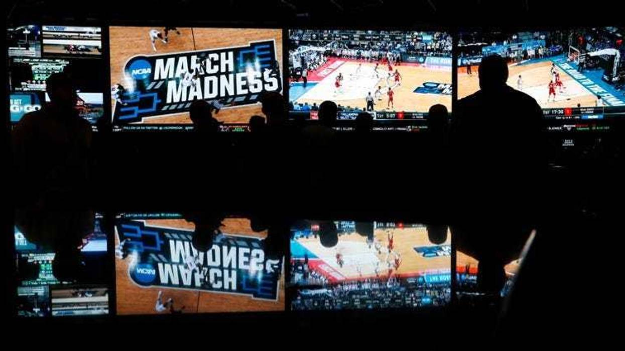In this March 15, 2018 photo, people watch coverage of the first round of the NCAA college basketball tournament at the Westgate Superbook sports book in Las Vegas.