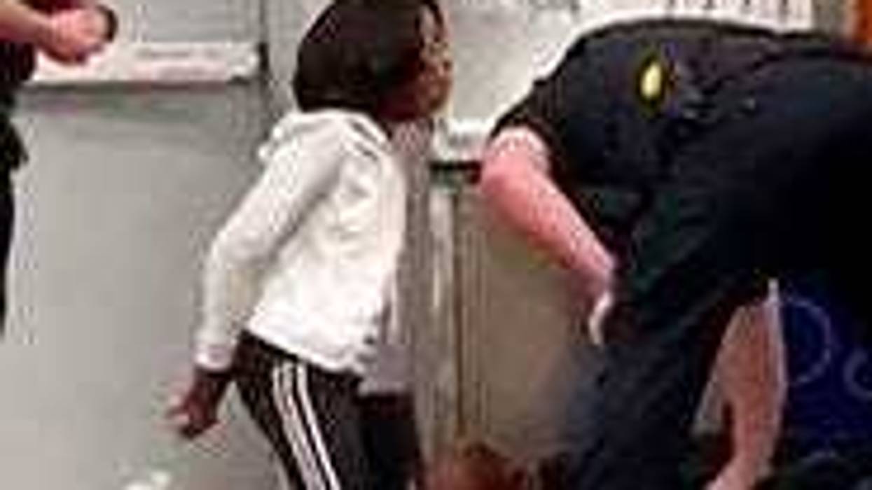 In this March 23, 2020 frame grab taken from video, Marvia Gray, is seen on her knees, while her son Derek Gray is seen face down as they are arrested at a Sam's Club store in Des Peres, Missouri. ( Photo courtesy Action Injury Law Group via AP)
