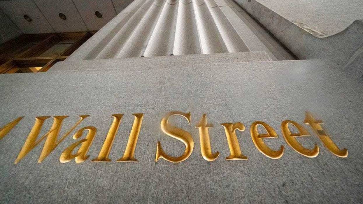 In this Nov. 5, 2020 file photo, a sign for Wall Street is carved in the side of a building. (AP Photo/Mark Lennihan, File)