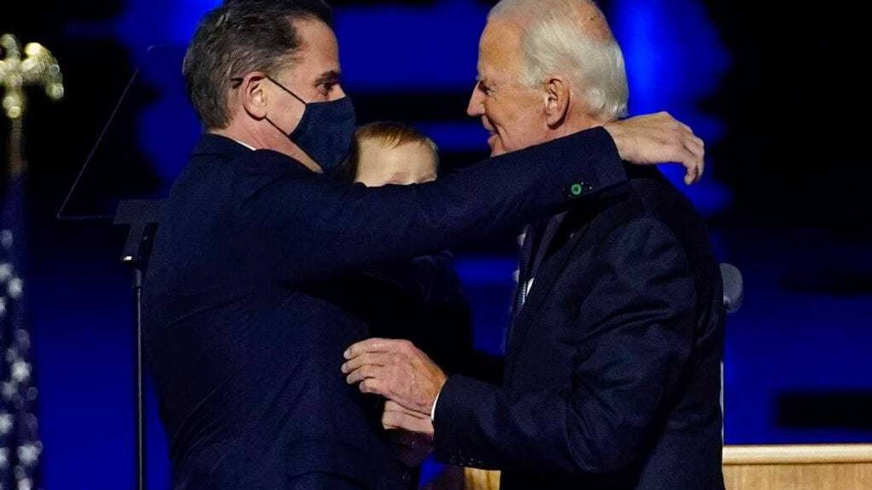 In this Nov. 7, 2020, file photo, Presidenet-elect Joe Biden, right, embraces his son Hunter Biden, left, in Wilmington, Del. (AP Photo/Andrew Harnik, Pool)