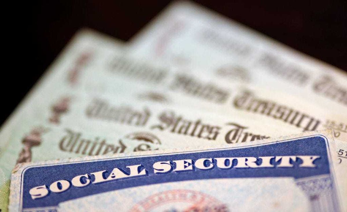 In this photo illustration, a Social Security card sits alongside checks from the U.S. Treasury on October 14, 2021 in Washington, DC.