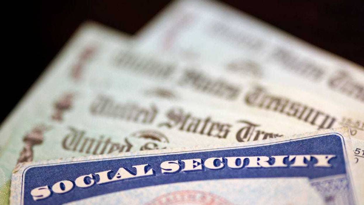 In this photo illustration, a Social Security card sits alongside checks from the U.S. Treasury on October 14, 2021 in Washington, DC.