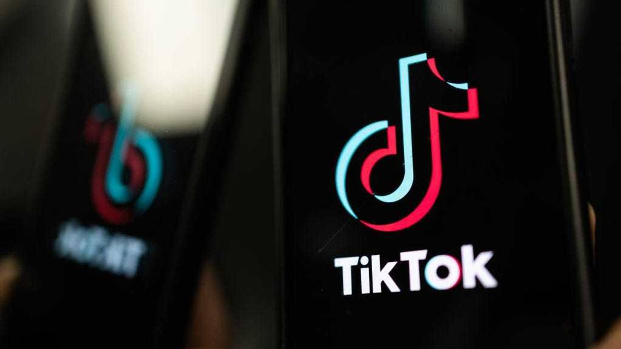 In this photo illustration, a TikTok logo is displayed on an iPhone on February 28, 2023 in London, England. This week, the US government and European Union's parliament have announced bans on installing the popular social media app on staff devices. (Photo by Dan Kitwood/Getty Images)