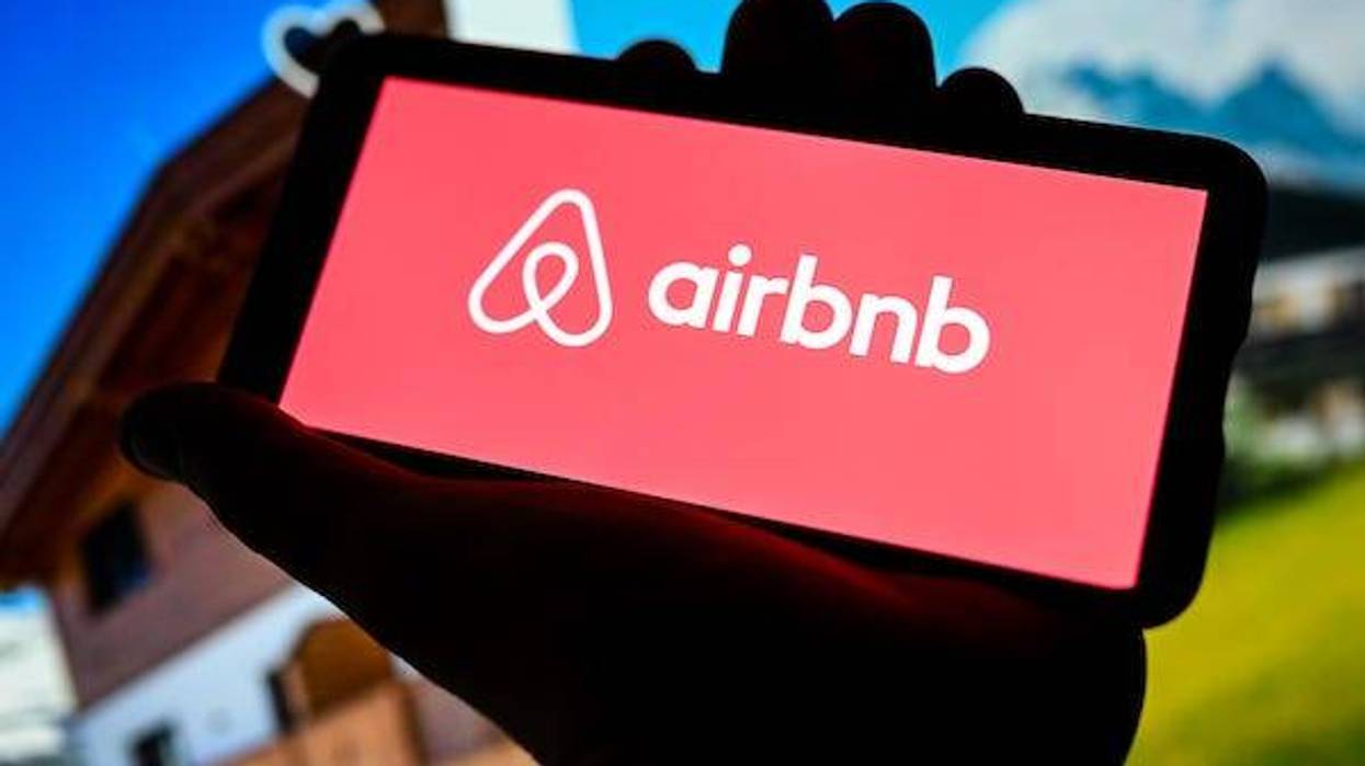 In this photo illustration an Airbnb logo seen displayed on a smartphone