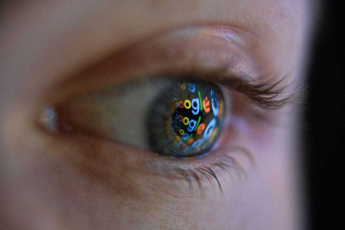 In this photo illustration, an image of the Google logo is reflected on the eye of a young man on August 09, 2017 in London, England.