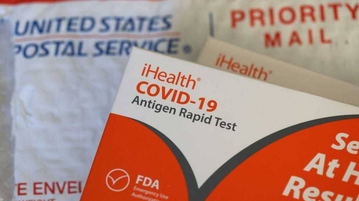 In this photo illustration, free iHealth COVID-19 antigen rapid tests from the federal government sit on a U.S. Postal Service envelope after being delivered on February 04, 2022 in San Anselmo, California.