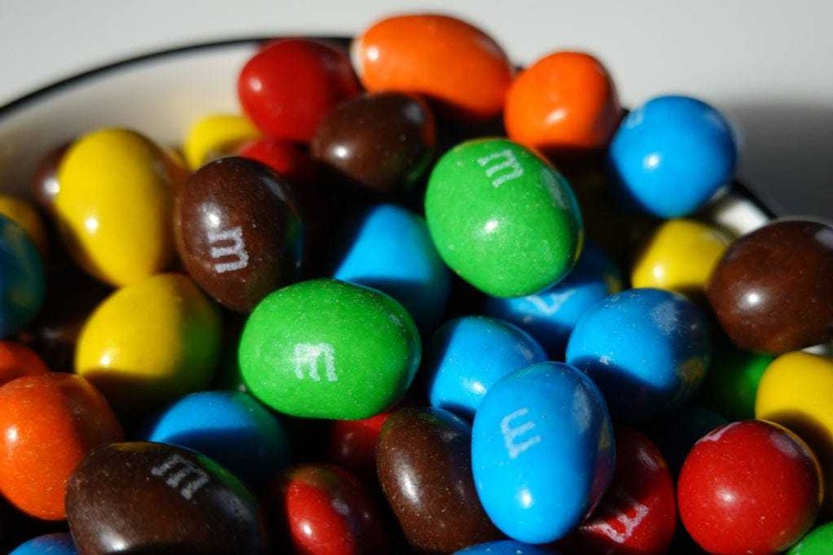 In this photo illustration, M&M's are piled in a container on January 24, 2023 in Miami, Florida. M&M's announced that its multi-colored cast of candy cartoon spokespeople will be retiring effective immediately, and will be replaced by comedian and Saturday Night Live alum Maya Rudolph. (Photo Illustration by Joe Raedle/Getty Images)