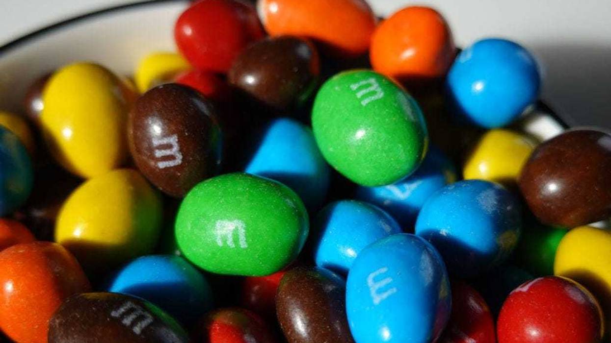 In this photo illustration, M&M's are piled in a container on January 24, 2023 in Miami, Florida. M&M's announced that its multi-colored cast of candy cartoon spokespeople will be retiring effective immediately, and will be replaced by comedian and Saturday Night Live alum Maya Rudolph. (Photo Illustration by Joe Raedle/Getty Images)