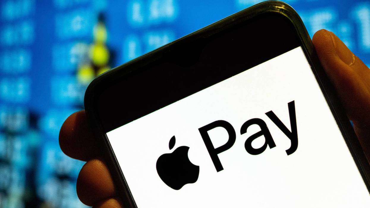 In this photo illustration, the mobile payment and digital wallet service by Apple, Apple Pay, logo is displayed on a smartphone screen.