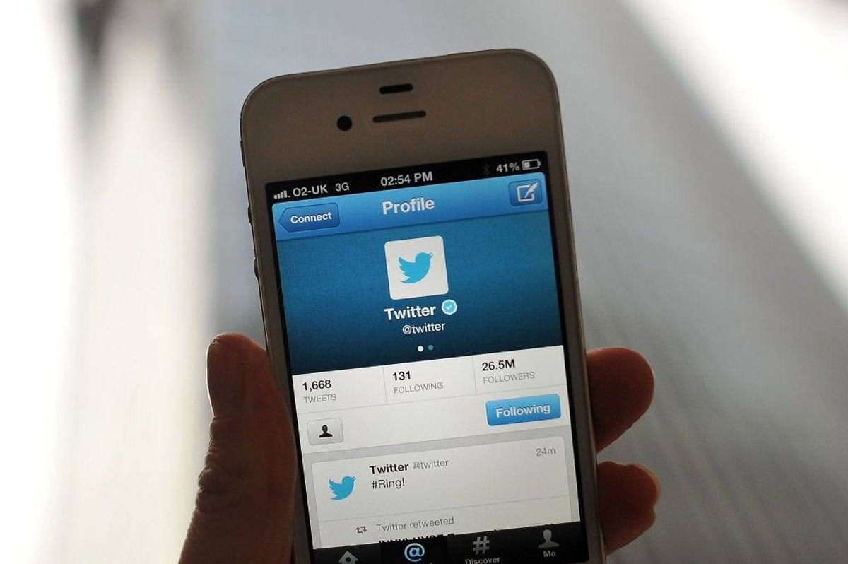 In this photo illustration, the Twitter logo and hashtag '#Ring!' is displayed on a mobile device as the company announced its initial public offering and debut on the New York Stock Exchange on November 7, 2013 in London, England.