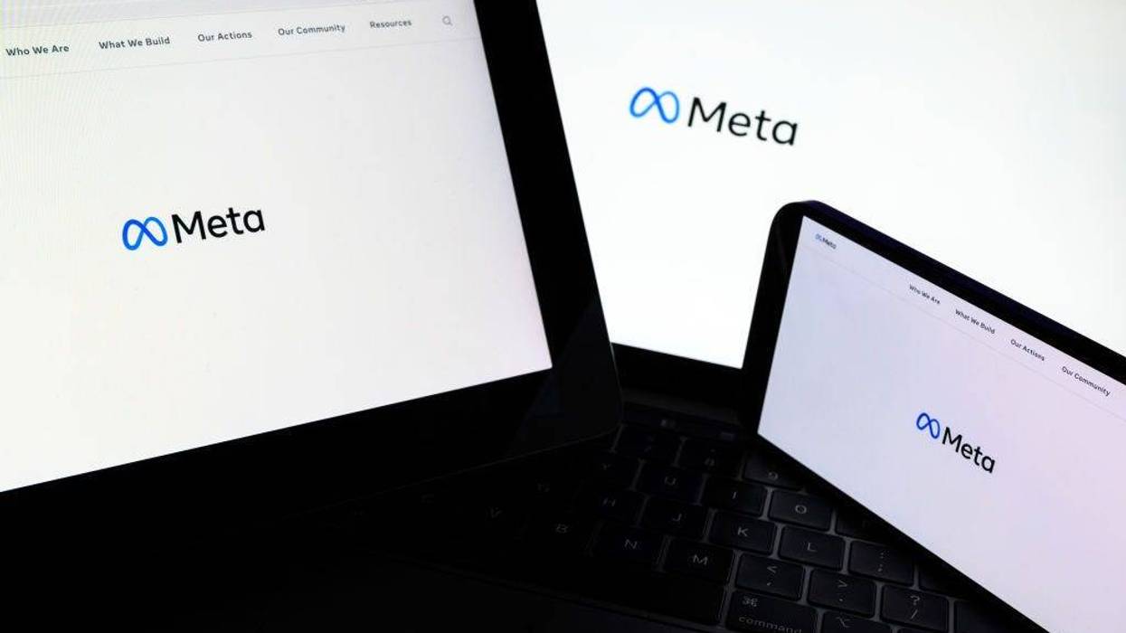 In this photo illustration, three screens display the splash page for the Meta page on the facebook website on October 29, 2021 in London, England.