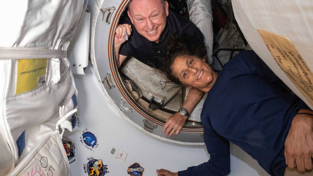 In this photo provided by NASA, Boeing Crew Flight Test astronauts Butch Wilmore, left, and Suni Williams pose for a portrait inside the vestibule between the forward port on the International Space Station's Harmony module and Boeing's Starliner spacecraft on June 13, 2024.