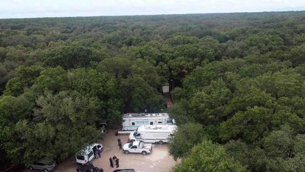 In this photo provided by North Port Police Department, law enforcement officials conduct a search of the vast Carlton Reserve in the Sarasota, Fla., area for Brian Laundrie on Saturday, Sept. 18, 2021