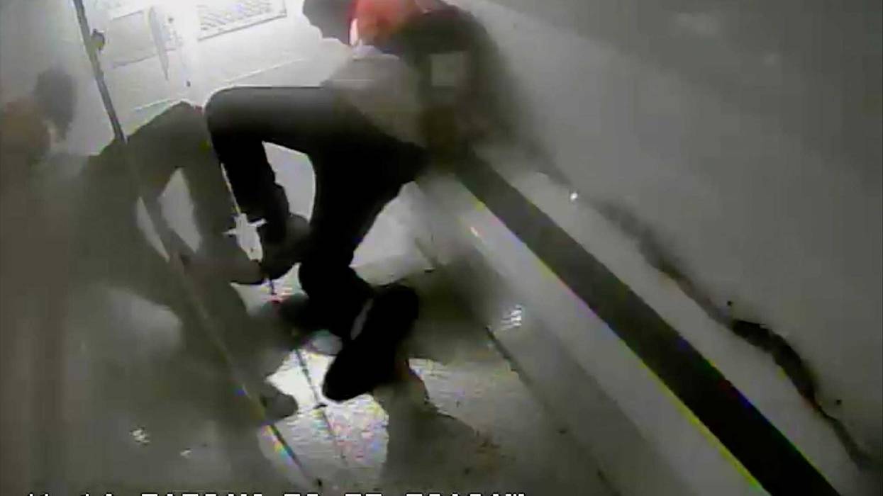 In this photo taken from surveillance video, Richard Cox slides down the back of a police van while being transported after being detained by New Haven Police, June 19, 2022, in New Haven, Conn. Officials in Connecticut said, Wednesday, June 22, 2022, that two New Haven officers have been placed on paid leave and three others were reassigned after Cox was seriously injured in the back of a police van.