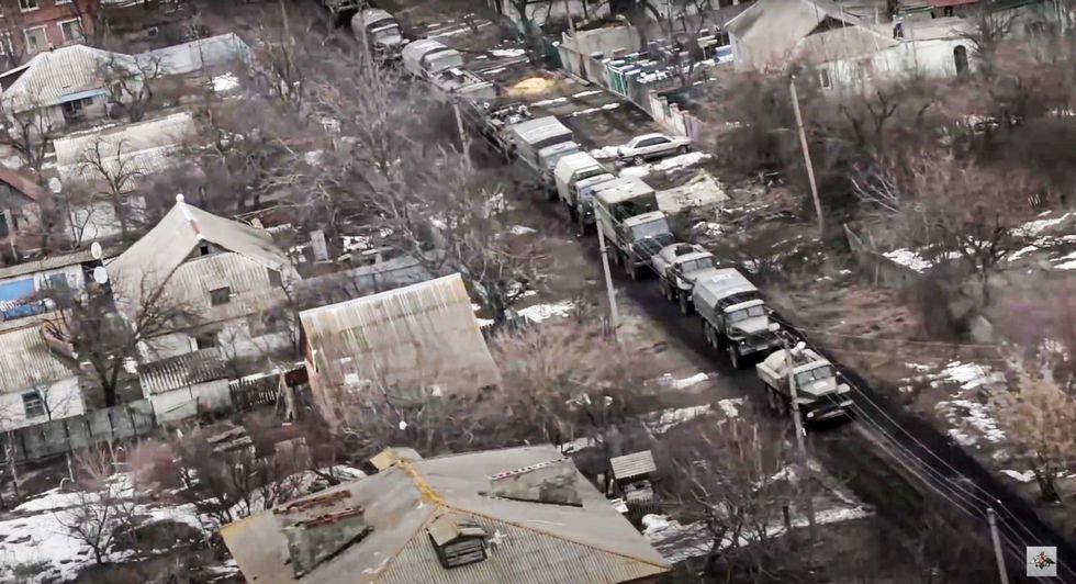 In this photo taken from video released by the Russian Defense Ministry Press Service on Thursday, March 3, 2022, a view from the window of a Russian military helicopter as it flies over an undisclosed location in Ukraine
