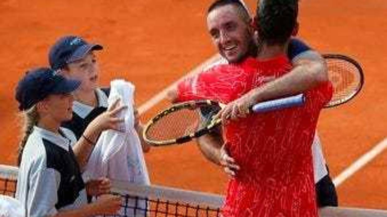In this Saturday, June 13, 2020 photo, Serbia's Novak Djokovic, front right, hugs with Serbia's Viktor Troicki after their match of the Adria Tour charity tournament in Belgrade, Serbia. (AP Photo/Darko Vojinovic)