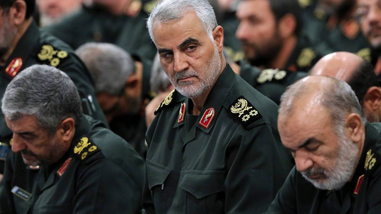 In this Sept. 18, 2016, file photo provided by an official website of the office of the Iranian supreme leader, Revolutionary Guard Gen. Qassem Soleimani, center, attends a meeting in Tehran, Iran.