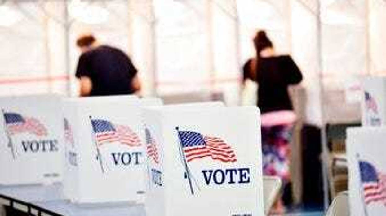 In this Sept. 8, 2020 photo, voting booths are kept socially distant at the Chesterfield, N.H. polling site. (Kristopher Radder/The Brattleboro Reformer via AP)