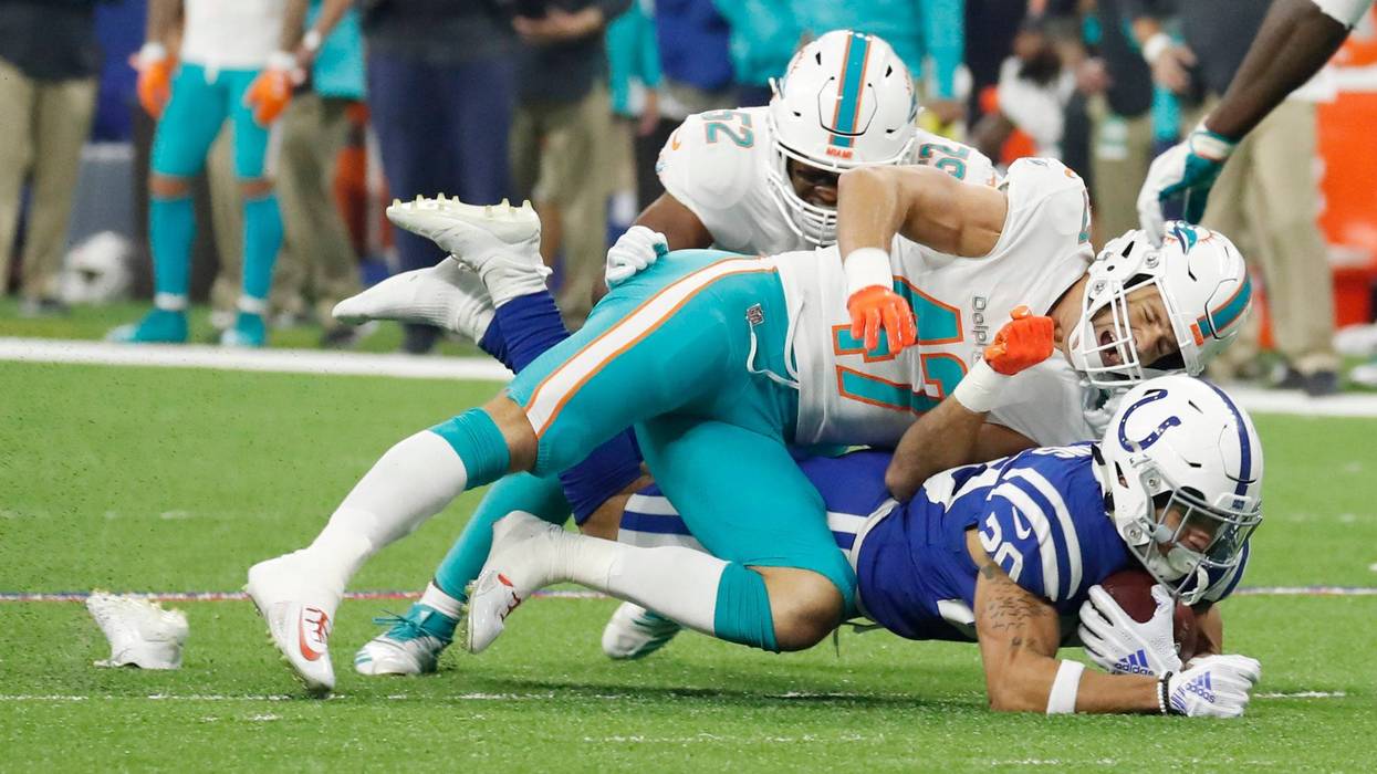 Indianapolis Colts running back Jordan Wilkins (20) loses his shoe as he is tackled by Miami Dolphins linebacker Kiko Alonso (47) during the first quarter at Lucas Oil Stadium.