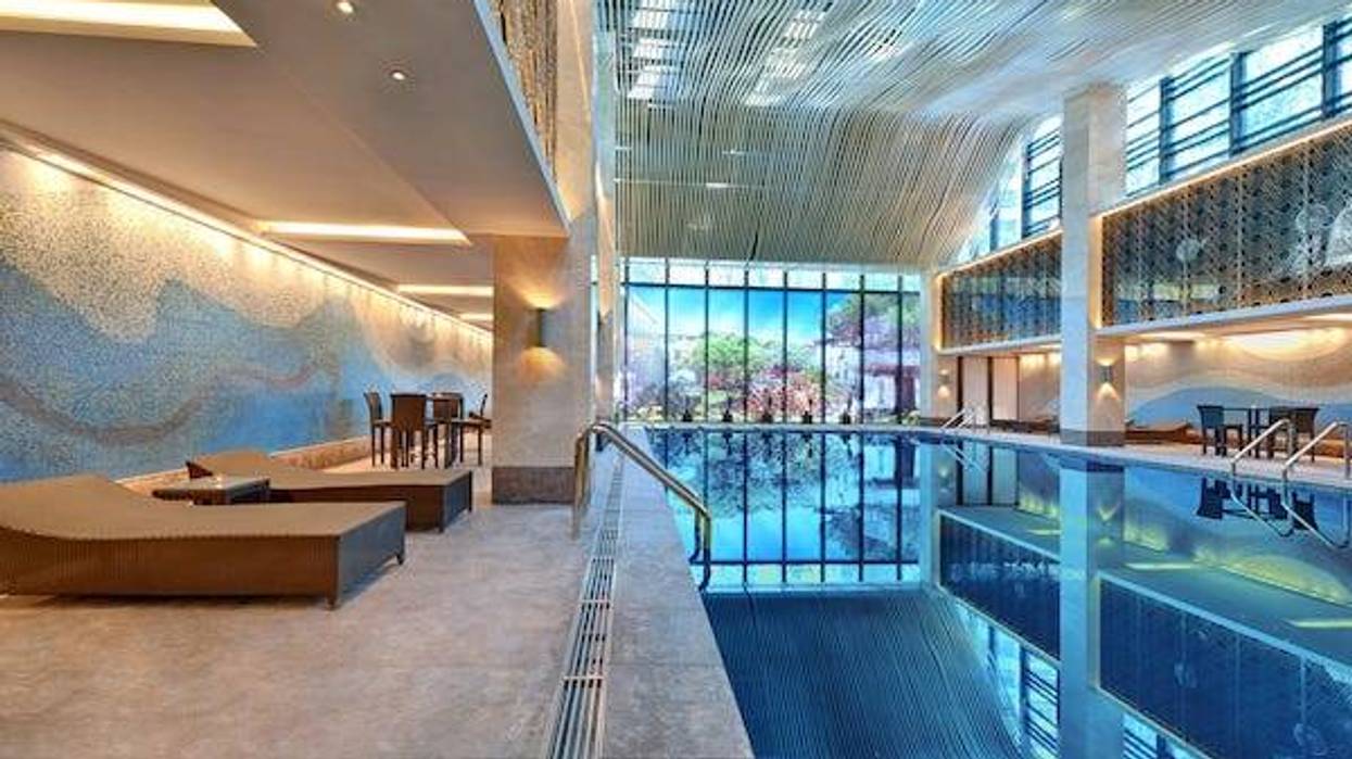 Indoor swimming pool with sun lounger on a bright day