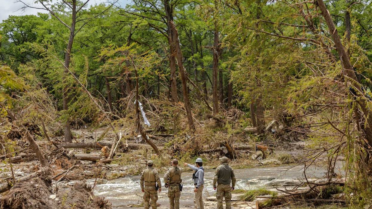 INGRAM, TEXAS - JULY 12: Crews scout out locations to send a cadaver dog team during continued search and recovery operations on the bank of the Guadalupe River during a search and recovery mission on July 12, 2025 in Ingram, Texas. More than 160 people are still missing after storm cells halted over the area, dumping nearly 15 inches of rain and causing a 22-foot rise along the Guadalupe River. (Photo by Jim Vondruska/Getty Images)