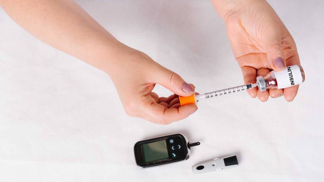 Insulin syringe for administering insulin to diabetic patients on white background. Diabetes treatment, drug addiction concept. High quality photo