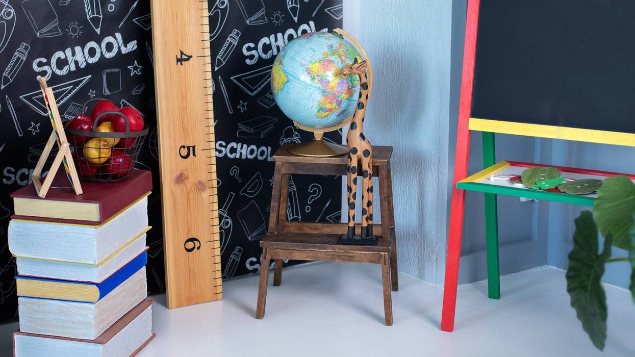 Interior of elementary school. Chalkboard, Books, globe and stationery on classroom. Teachers Day concept. Back to school. Empty classroom with blackboard. Kindergarten. Interior of children's room