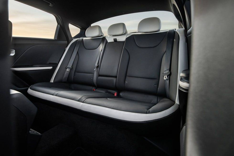 Interior view of a car featuring sleek black leather seats, showcasing a modern and stylish design.