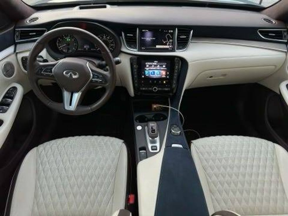 Interior view of a high-end car showcasing premium leather seating and a sophisticated dashboard.