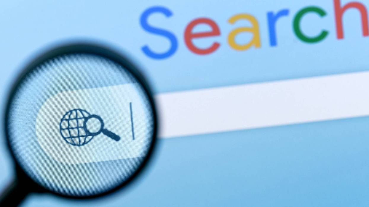 Internet search bar in browser with magnifier on computer monitor screen.