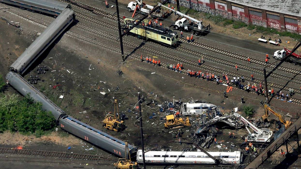 Investigators and first responders work near the wreckage of an Amtrak passenger train carrying more than 200 passengers from Washington, D.C. to New York that derailed on May 12, 2015, in North Philadelphia, Pennsylvania.