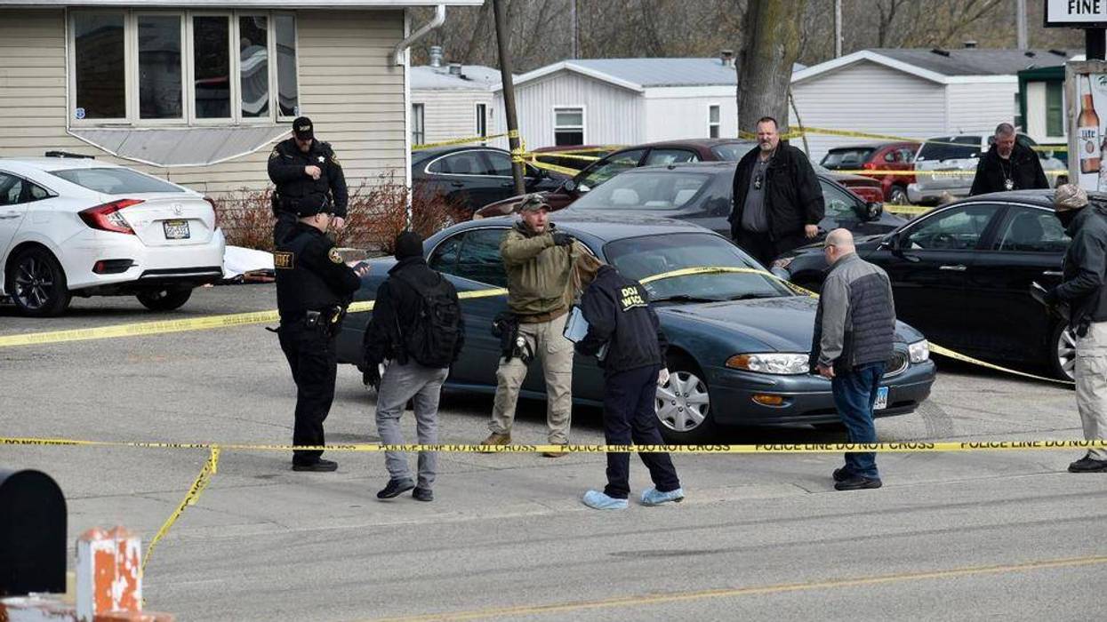 Investigators confer during an investigation outside the Somers House Tavern, in Kenosha, Wis., Sunday morning, April 18, 2021. Authorities say several people were killed and a few were seriously wounded in a shooting early Sunday at the tavern in Kenosha County in southeastern Wisconsin.
