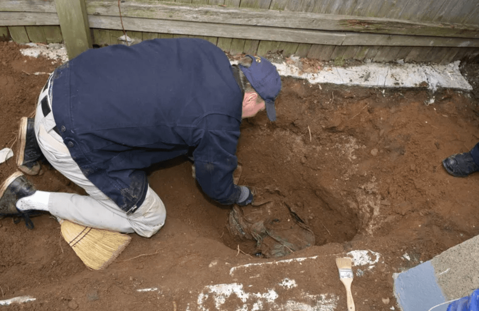 Investigators in the backyard of a home in Richmond Hill where Martin Motta buried the remains of George Clarence Seitz.